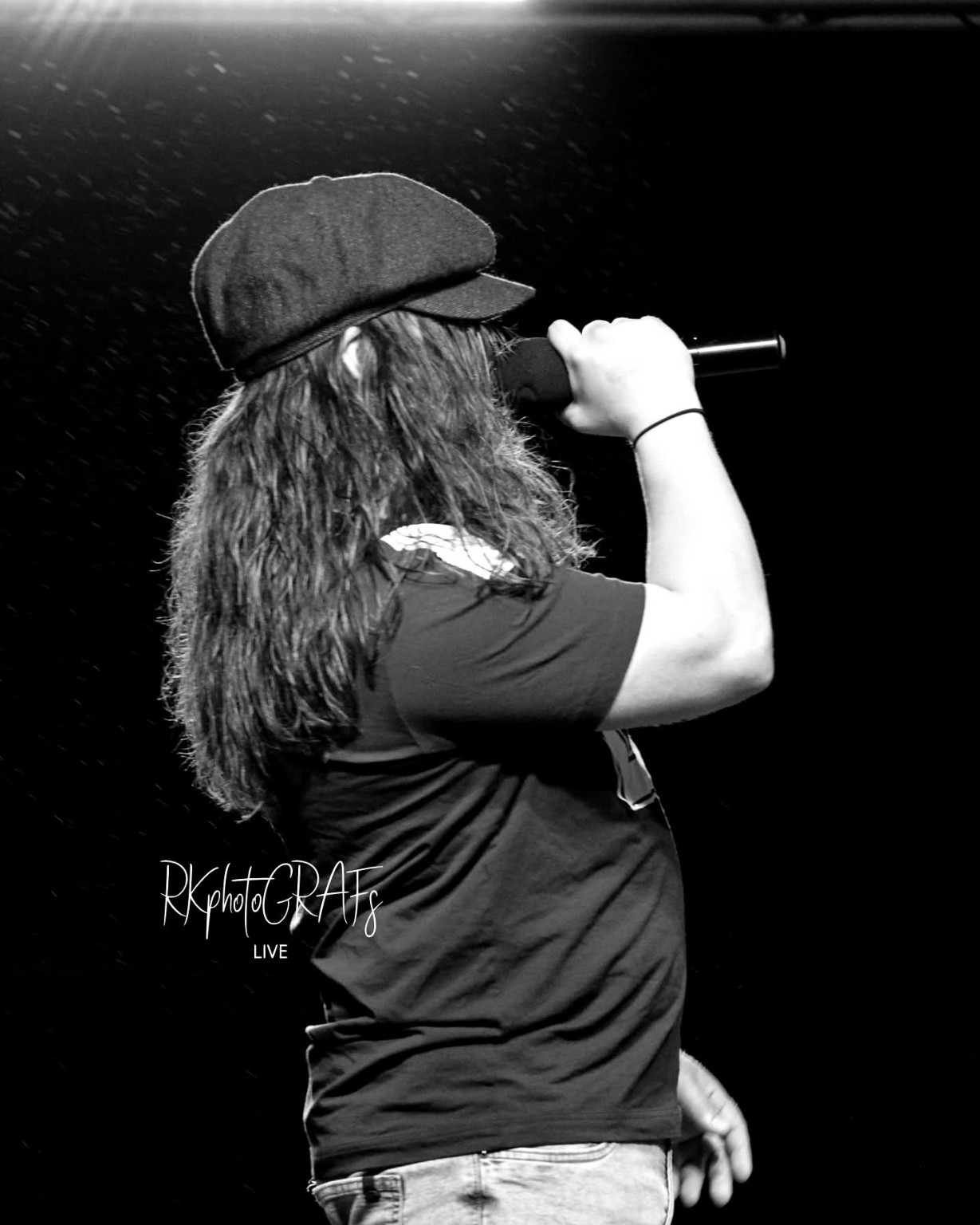 AC/DC ERAS vocalist in a flat cap, photographed live in black and white
